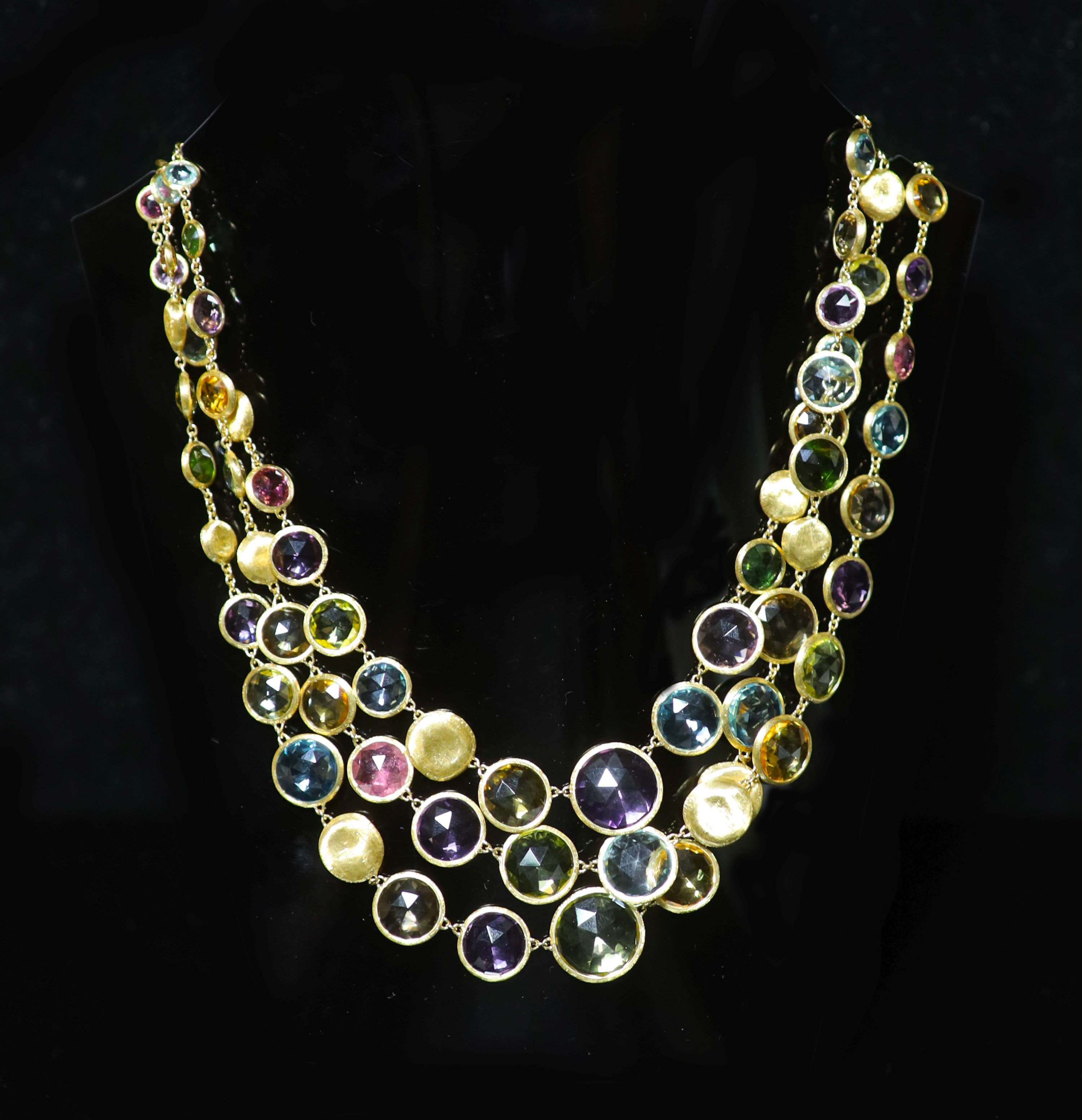 A modern Italian gold and graduated multi gem set three row spectacle necklace by Marco Bicego